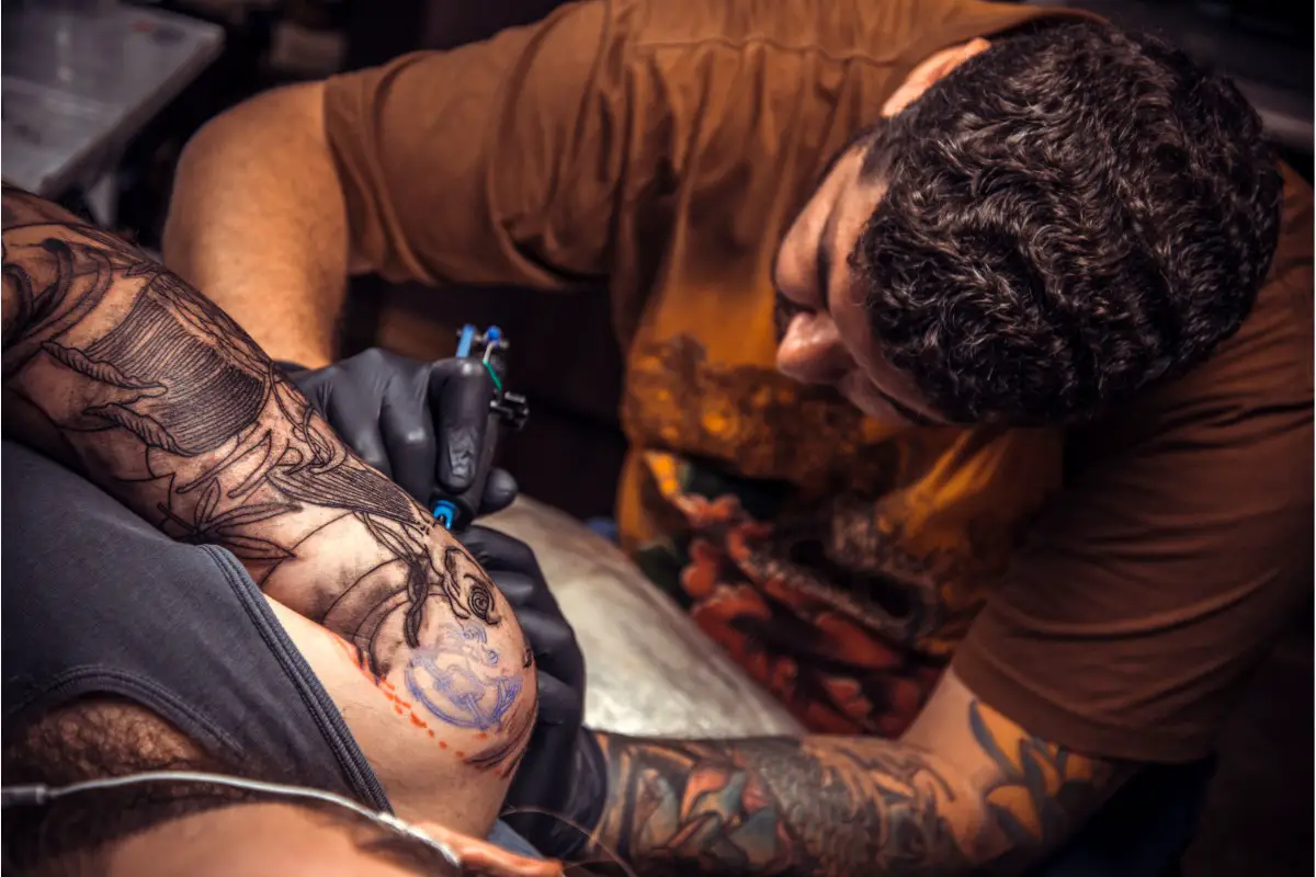 Tattoo artist working tattooing