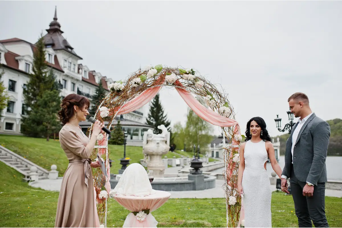 wedding ceremony against decor arch